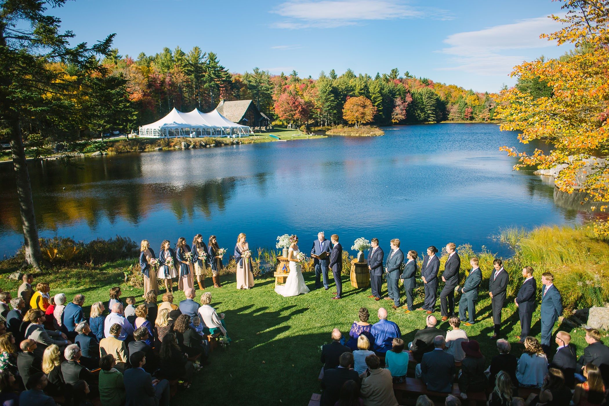 A couple by the water in peak fall color