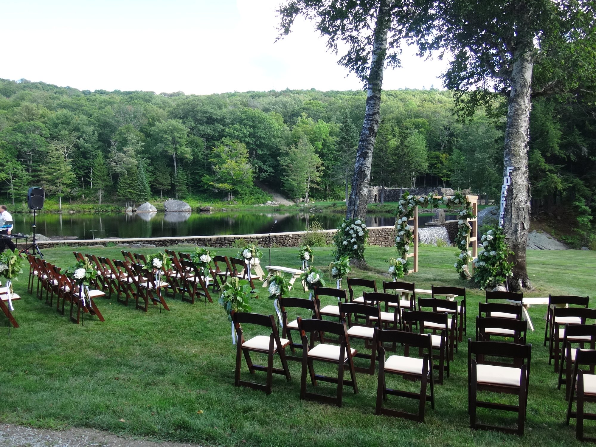 The waterfall ceremony lawn framed by old millstones