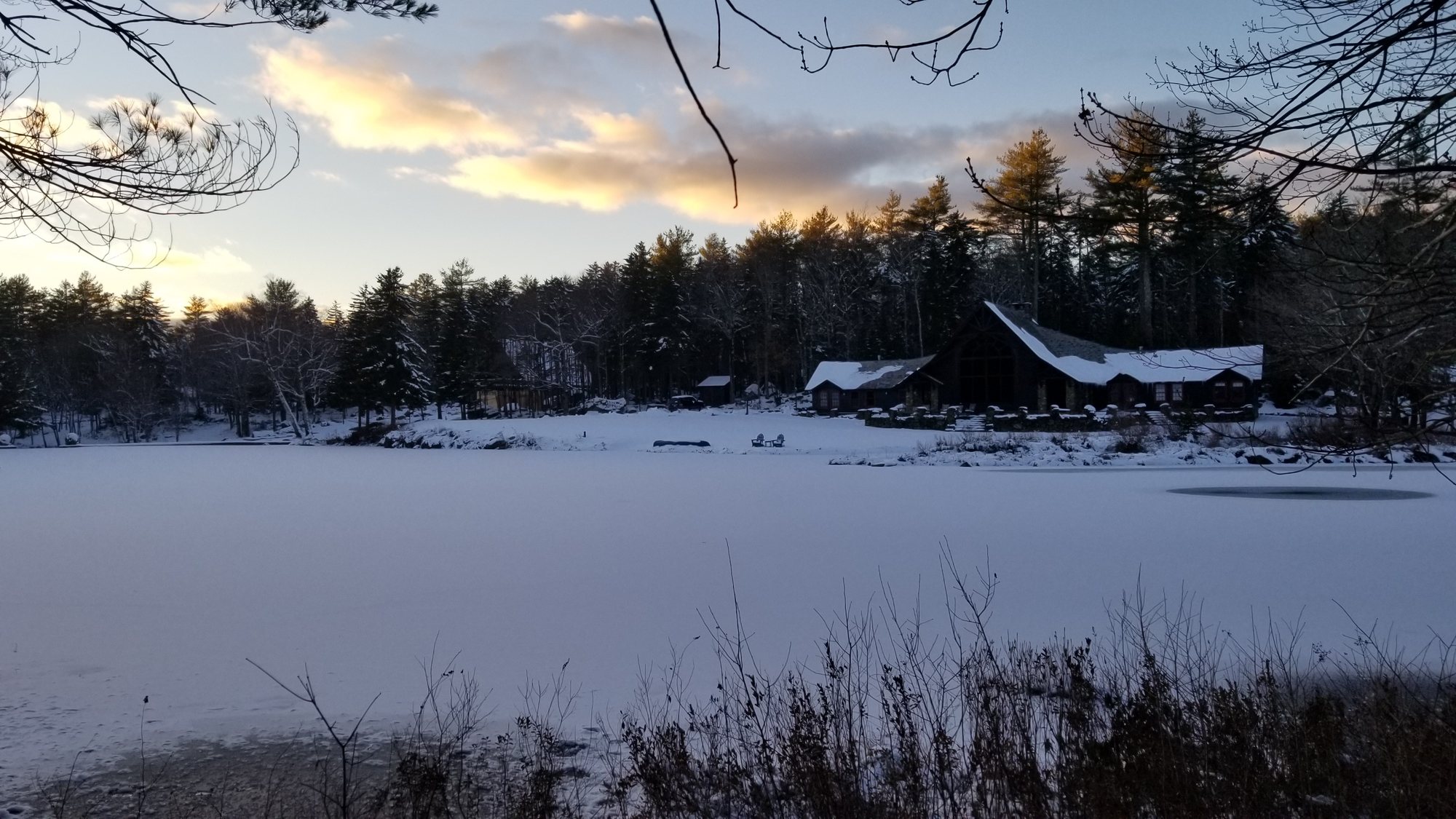 The Lodge across the frozen pond at sunset
