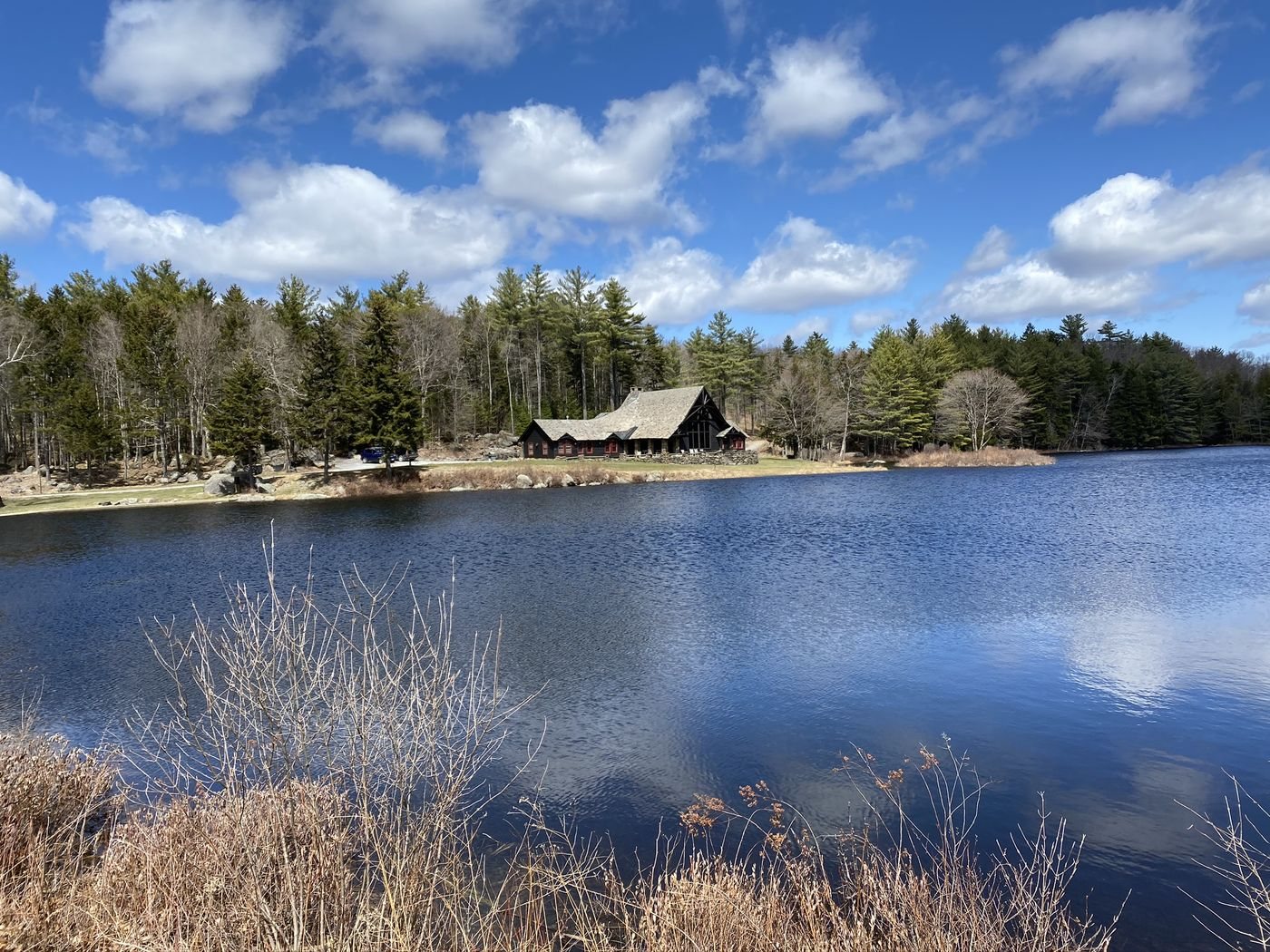The Lodge across the pond under a summer sky