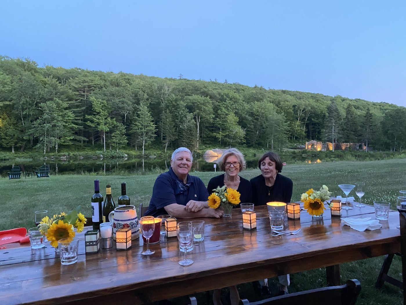 The Healy family at a long table on the lawn at dusk