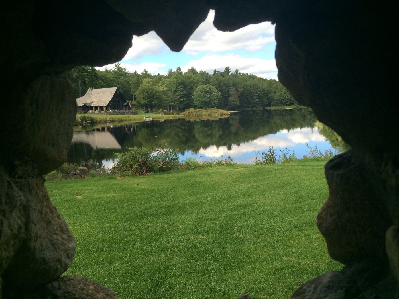 The Lodge seen through a stone arch in spring