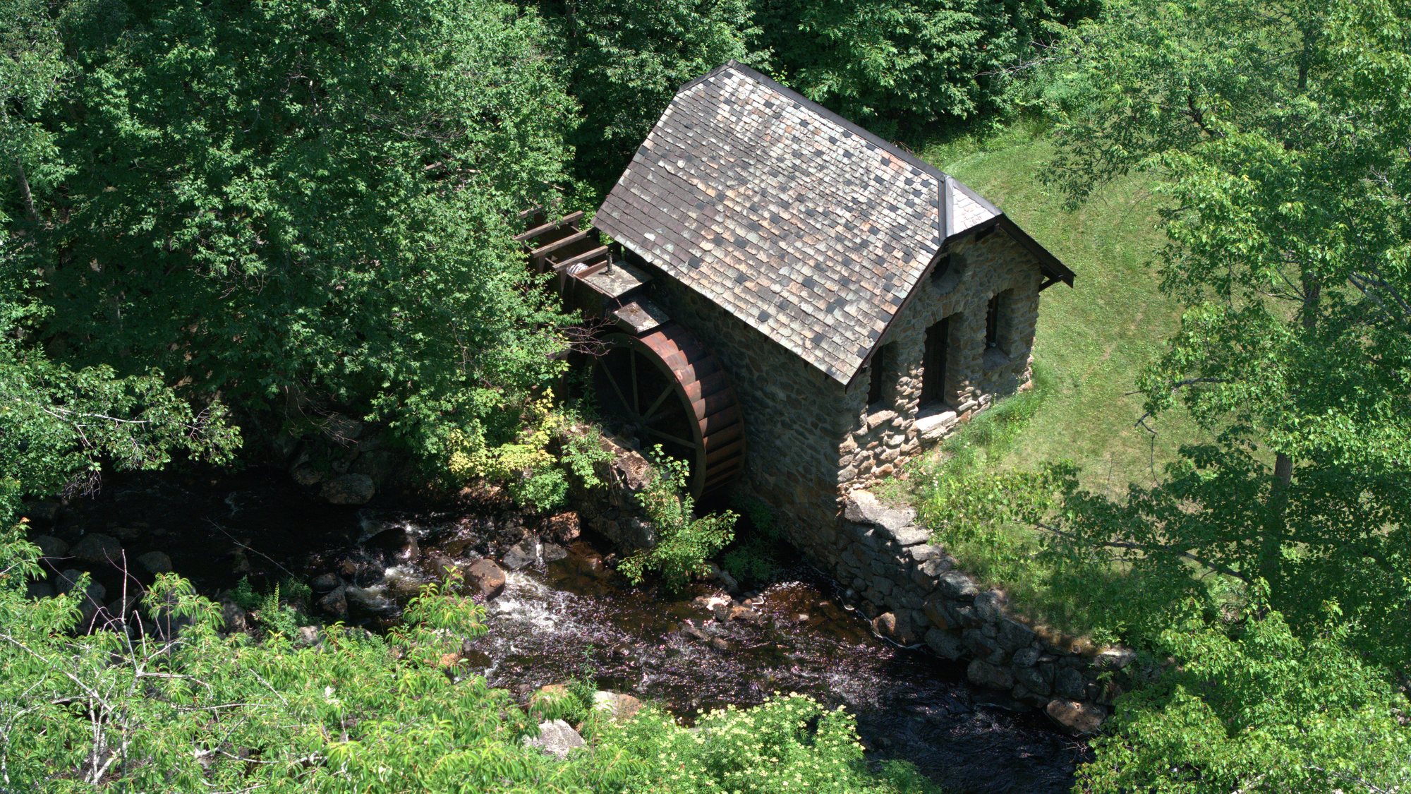 The stone powerhouse and its waterwheel on Otter Brook