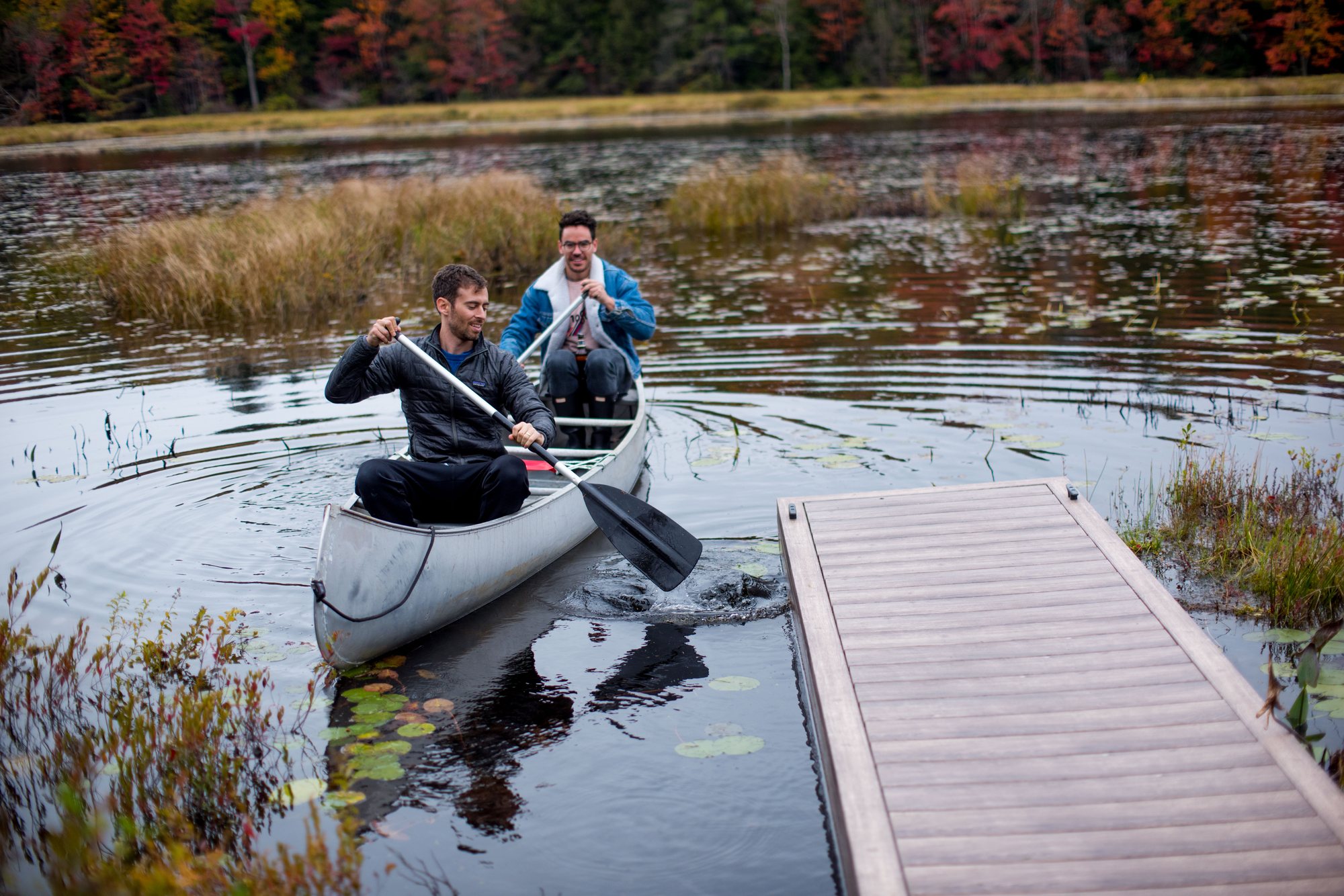 Two paddlers crossing the marsh in a canoe in October