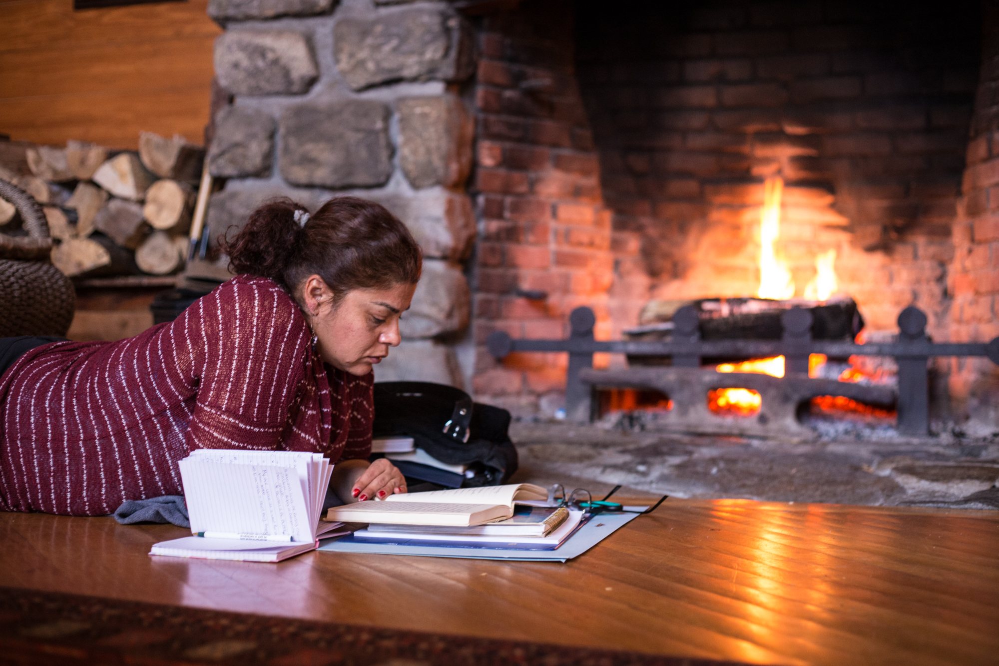 Reading by the stone fireplace