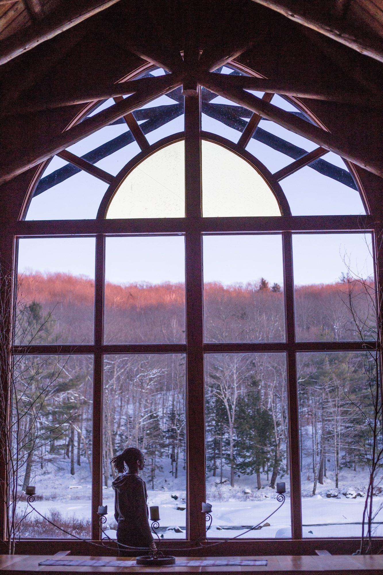 The arched window of the Lodge at dusk in winter