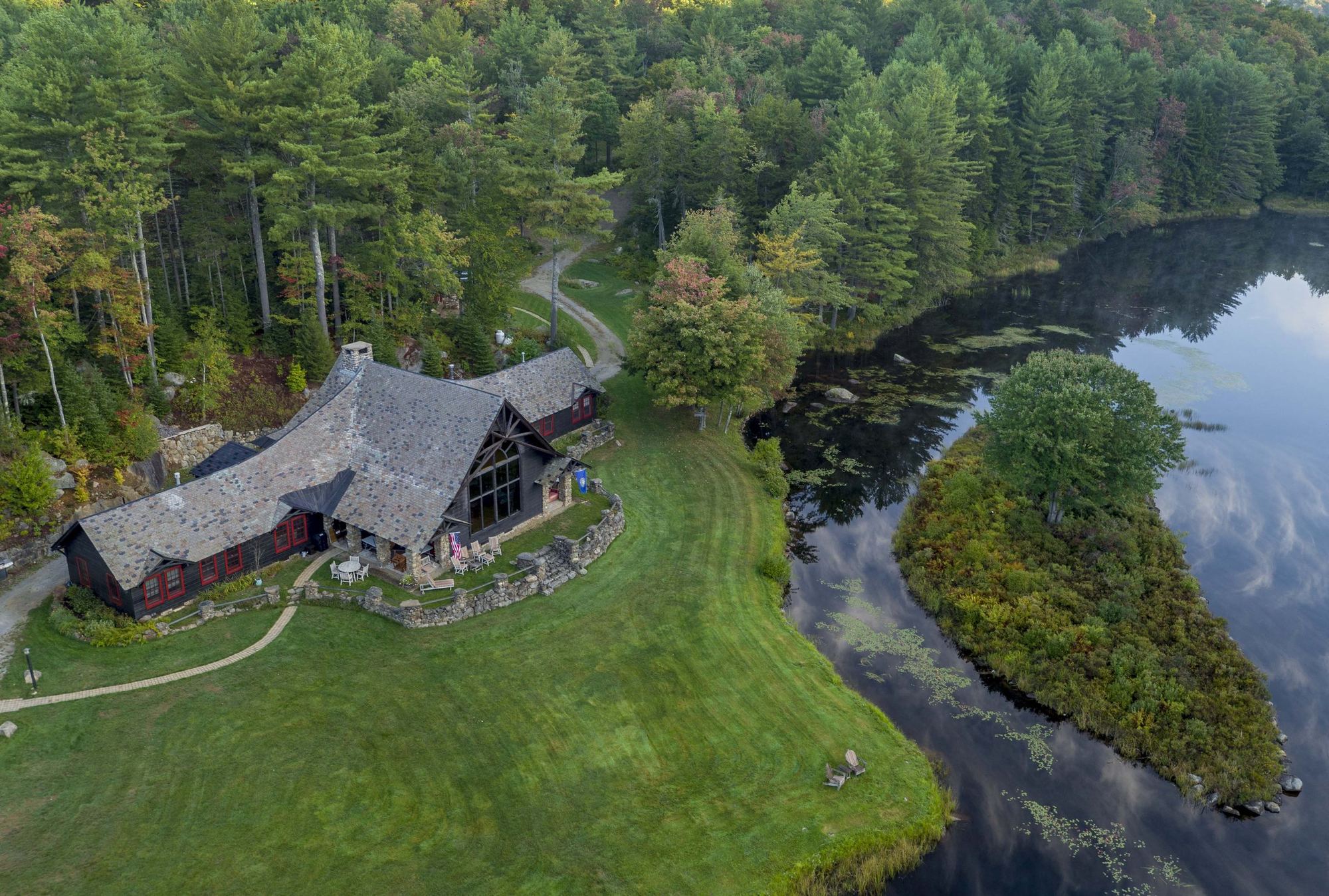 The Lodge on its point in Woods Mill Pond, its lawn running to the water, from above