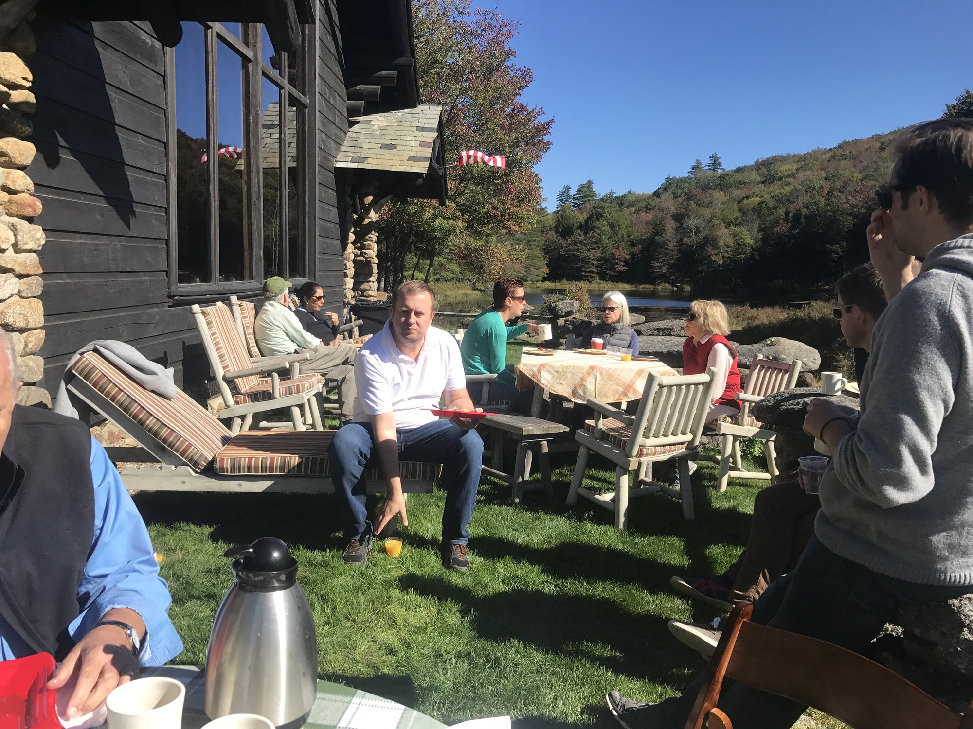 Friends and family relaxing on the Lodge lawn in the sun