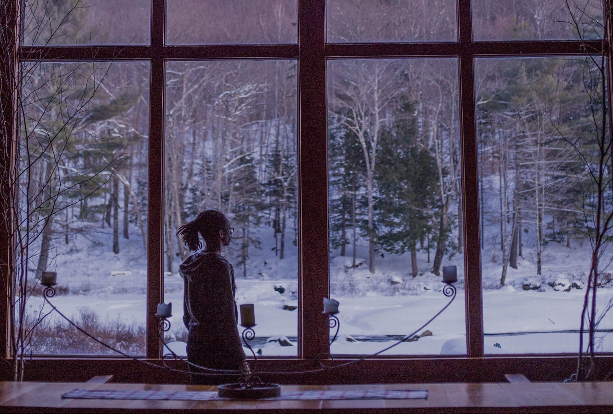 The Lodge window at dusk over the frozen pond
