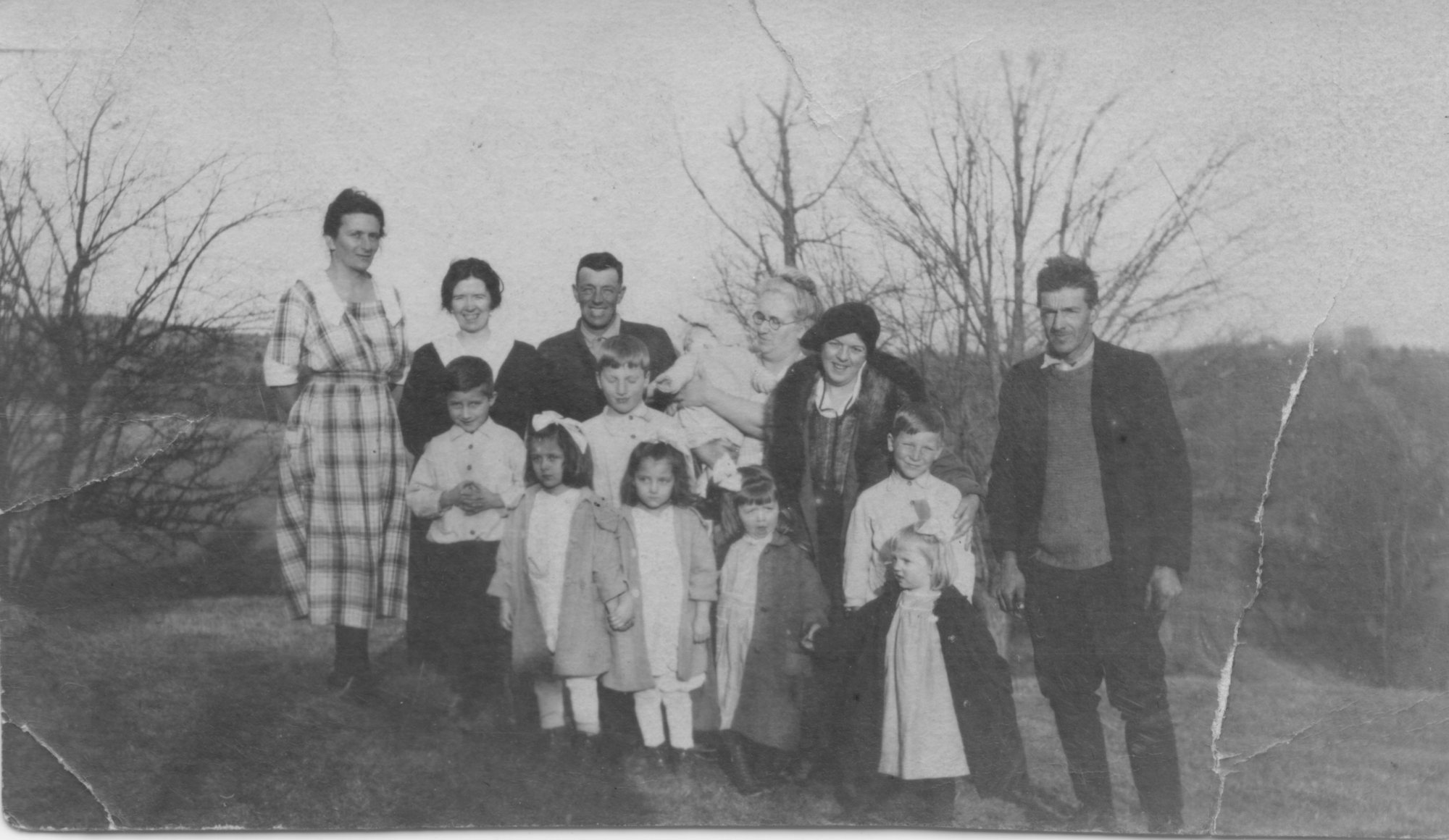 A family group posed outdoors, Florence Brooks Aten among them