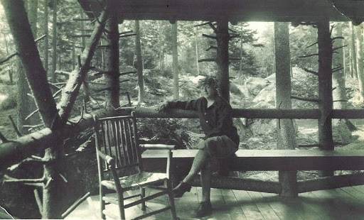 Florence Brooks Aten on a porch in the woods